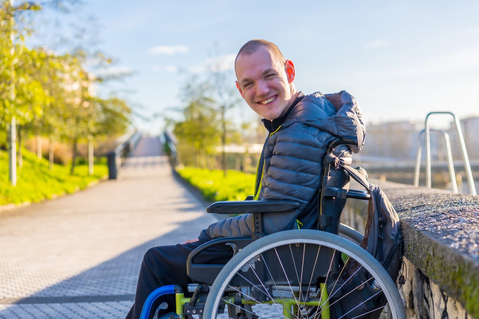Portrait of a disabled person in a wheelchair in the city sunset